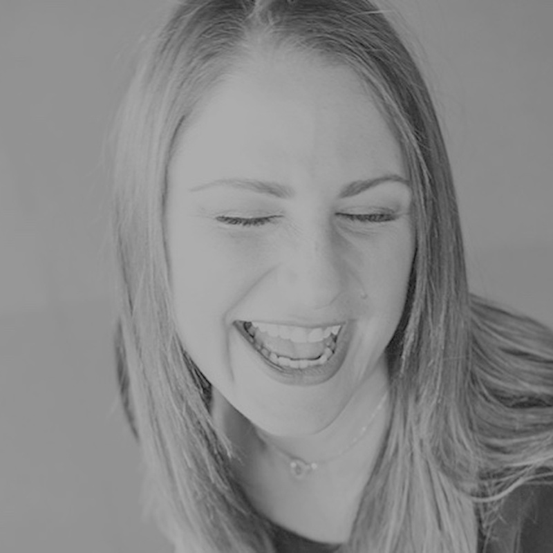 Sage Recruiting team member laughing, black and white close-up photo